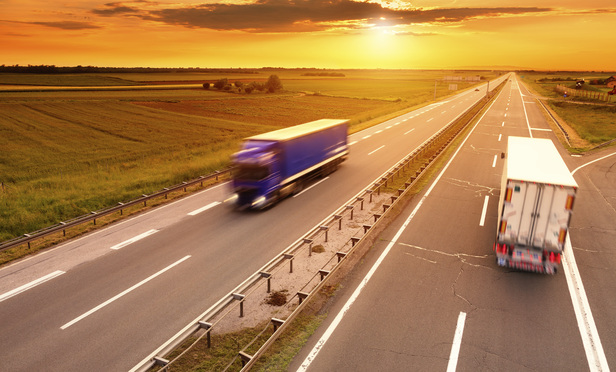 Trucks Driving on Road